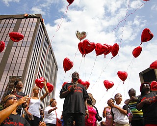MADELYN P. HASTINGS | THE VINDICATOR..Several people release balloons in honor of loved ones killed in violence during the ÒLetÕs MoveÓ block party in downtown Youngstown on Saturday, August 10, 2013. The block party was a health-oriented activity, from 10 a.m. to 5 p.m. focused on Michelle ObamaÕs project of physical activity Ñ ÒLetÕs Move.Ó The party featured zumba, line dancing, basketball and an obstacle course. ... - -30-..