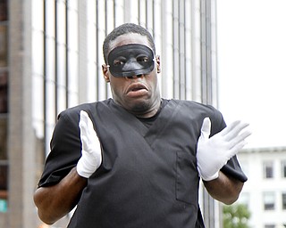 MADELYN P. HASTINGS | THE VINDICATOR..Michael Cotton performs with the group New Bethel Church Mime Ministry during the ÒLetÕs MoveÓ block party in downtown Youngstown on Saturday, August 10, 2013. The block party was a health-oriented activity, from 10 a.m. to 5 p.m. focused on Michelle ObamaÕs project of physical activity Ñ ÒLetÕs Move.Ó The party featured zumba, line dancing, basketball and an obstacle course. ... - -30-..