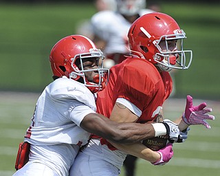 Youngstown Sate receiver #2 Christian Bryant is wrapped up by defensive back #31 David Rivers after a catch near the sideline during a scrimmage on August 10, 2013.