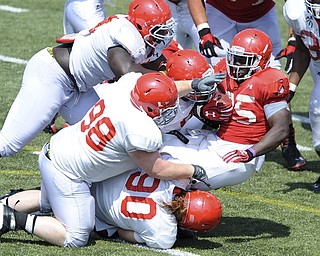 Youngstown State running back #25 Torrian Pace is stopped be defenders #90 Eric Myers, #98 D.J. Moss, #91 Mike Palumbo and another defender (I can't see a number on any shot I have front he sequence) during a scrimmage on August 10, 2013.