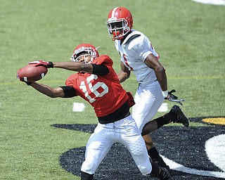 Youngstown State receiver #16 Marcel Caver catches a pass downfield after getting behind defensive back #31 David Rivers during a scrimmage on August 10, 2013.