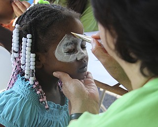 Jalaya Bumm (4) of Youngstown gets her face painted during the Goodness Invasion at the Covelli Center in Youngstown on Saturday morning. Dustin Livesay | The Vindicator 8/10/13 Covelli Center.