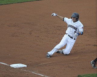 Scrappers #9 Paul Hendrix slides into third base after hitting a two RBI triple in the bottom of the 1st inning during a game between the Scrappers and Renegades on August 10, 2013.