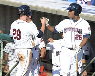 Scrappers base runner #29 Ryan Battaglia is congratulated by teammate #25 Nelson Rodriguez after scoring the Scrappers first run in the bottom of the 2nd inning during a game between the Scrappers and Renegades on August 1, 2013.
