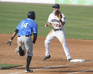Scrappers first basemen #29 Ryan Battaglia catches the baseball with his foot on first base to force out Renegades base runner #14 Darryl George in the top of the 5th inning during a game between the Scrappers and Renegades on August 1, 2013.