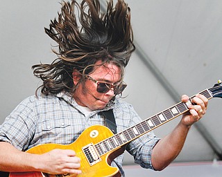 Trevor Harlot of Scarlet and the Harlots plays guitar during a set by the band from Kent during VexFest 9 on Sunday in downtown Youngstown. Twenty-five bands played on two sites on East Federal Street and at Warehouse 50.