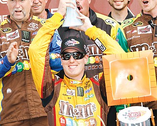 Kyle Busch celebrates in Victory Lane on Sunday after holding off Brad Kelselowski to win the Cheez-It 355 at The Glen in Watkins Glen, N.Y.