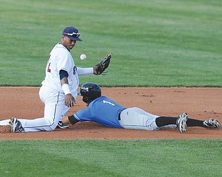 Renegades baserunner Johnny Field safely steals second base as the ball gets away from Scrappers infielder Claudio Bautista during the fourth inning of a New York-Penn League baseball game Sunday at Eastwood
Field in Niles. The game got away from Mahoning Valley in the eighth inning when the Renegades rallied and
scored five runs to win 6-5.