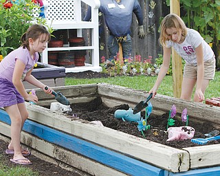 Addison, 7, and Taylor Bycroft, 10, both of East Palestine, play in the “dig area” of the Family Garden at Mill Creek MetroParks’ Fellows Riverside Gardens. The Family Garden is a priority for expansion under the master plan, or Gardens Northwest Project.