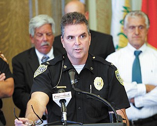 Youngstown Police Chief Rod Foley speaks with reporters Monday after announcing that 11 of 13 members of an East Side street gang around the Victory Estates housing projects were in custody.