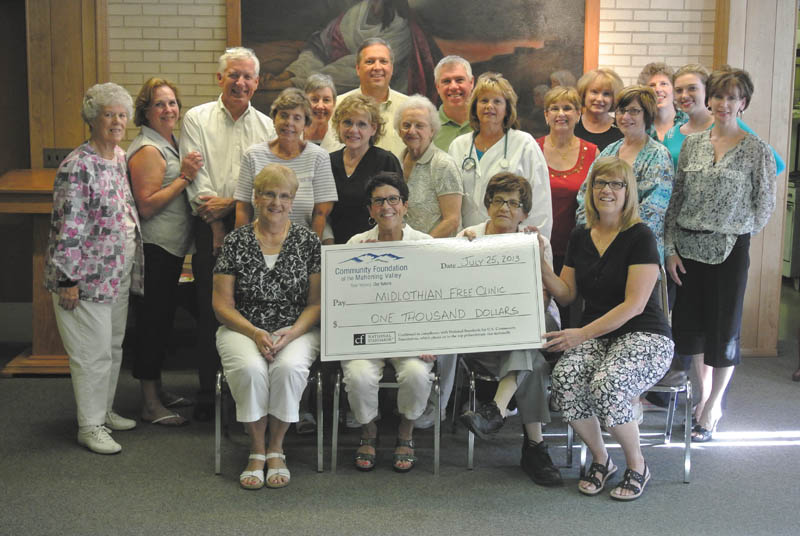 SPECIAL TO THE VINDICATOR
The Diabetes Partnership of the Mahoning Valley board members including Ed Hassay, third from left in the back row, and Marguerite Hassay, Jean Rider and Marsha Kamensky, holding the check, presented the donation to the Midlothian Free Health Clinic July 25. In the front row at left is Carol J. Beard, registered nurse and head nurse of the clinic, who accepted the check, and Dr. Thomas Albani, fifth from left in the back row. They are shown with a number of clinic volunteers. The donation was provided by the partnership and an anonymous friend of DPMV for the care of an increasing population of diabetic clinic patients. Visit DPMV at the Canfield Fair in the medical building or at www.diabetespartnershipmv.org.
