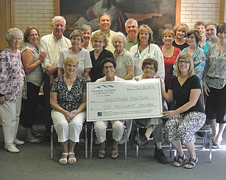 SPECIAL TO THE VINDICATOR
The Diabetes Partnership of the Mahoning Valley board members including Ed Hassay, third from left in the back row, and Marguerite Hassay, Jean Rider and Marsha Kamensky, holding the check, presented the donation to the Midlothian Free Health Clinic July 25. In the front row at left is Carol J. Beard, registered nurse and head nurse of the clinic, who accepted the check, and Dr. Thomas Albani, fifth from left in the back row. They are shown with a number of clinic volunteers. The donation was provided by the partnership and an anonymous friend of DPMV for the care of an increasing population of diabetic clinic patients. Visit DPMV at the Canfield Fair in the medical building or at www.diabetespartnershipmv.org.