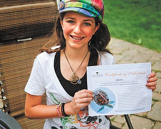 Eleven-year-old Quinn Barton of Poland supports the proper care for marine life and animals that end up in shelters by adopting sea turtles, using her allowance and the money she earns by baby-sitting her brothers. Photo by: MADELYN P. HASTINGS | THE VINDICATOR