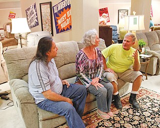 From left, Steve Sanchez, Jackie Calvert and Andy Canady sit on a sofa at the going-out-of-business sale at Bolotin Furniture in Hermitage. The store will be closing after 107 years in business.