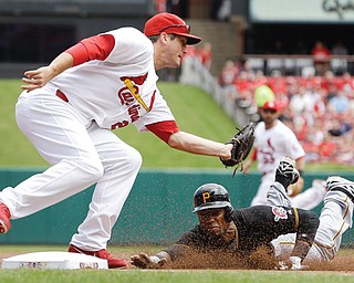 Cardinals third baseman David Freese prepares to tag out the Pirates’ Starling Marte on a steal attempt during the first inning of Thursday’s baseball game in St. Louis. The game was tied 5-5 until the 12th when Matt Holliday hit a walk-off single to score Matt Carpenter and lift the Cardinals over the Pirates, 6-5.