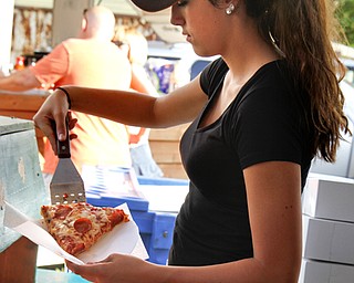 MADELYN P. HASTINGS | THE VINDICATOR

Julia Dolak, 16, serves Pasquale's pizza at the Brier Hill Italian Festival, the longest continuously running Italian Fest in the city of Youngstown, on Saturday, August 17, 2013. The event features games, food, table vendors and live music. and runs through Sunday.