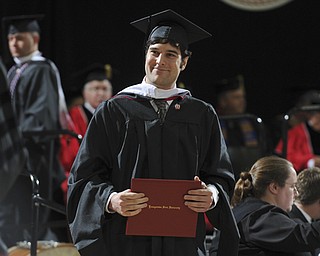Ryan Antonucci smiles walking off the stage after receiving his masters degree during the summer commencement ceremony Saturday morning at Beeghley Center.