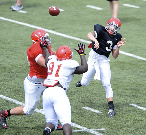 Youngstown State quarterback #3 Dante Nania throws a pass from the pocket avoiding the pass rush from #91 Mike Palumbo.