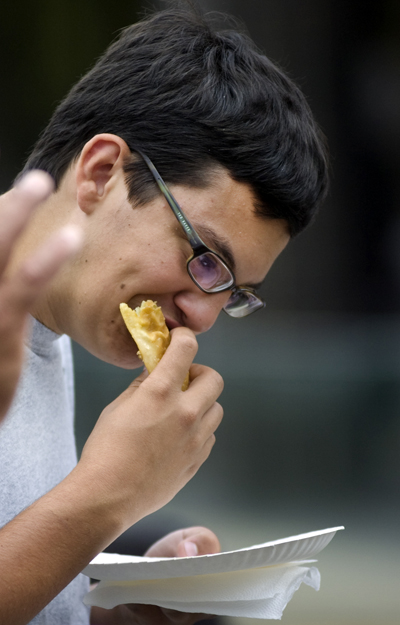 Kelli Cardinal/The Vindicator
Antonio Montanez, from Campbell, eats a pastelillos de carne or "meat pie" on Sunday during the Spanish Heritage Festival in downtown Youngstown.