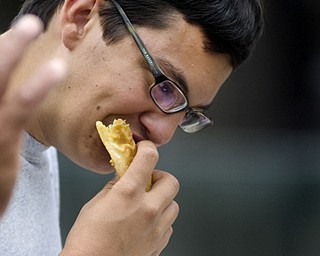 Kelli Cardinal/The Vindicator
Antonio Montanez, from Campbell, eats a pastelillos de carne or "meat pie" on Sunday during the Spanish Heritage Festival in downtown Youngstown.