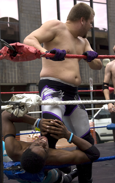 Kelli Cardinal/The Vindicator
Lou Lindstrom, top, keeps a hold Sunday on competitor Chase Aaryons (ok), both from Highstakes Battleground Wrestling, during a triple threat match at the Spanish Heritage Festival in downtown Youngstown.