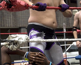 Kelli Cardinal/The Vindicator
Lou Lindstrom, top, keeps a hold Sunday on competitor Chase Aaryons (ok), both from Highstakes Battleground Wrestling, during a triple threat match at the Spanish Heritage Festival in downtown Youngstown.