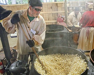 MADELYN P. HASTINGS | THE VINDICATOR
Brian Payne makes popcorn at the Original Kettle Corn booth at the Shaker Woods Festival in Columbiana on Sunday, August 18, 2013.