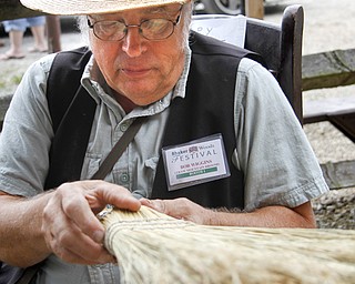 MADELYN P. HASTINGS | THE VINDICATOR
Bob Wiggins examines a broom made by Rich Evans at the Straw Mountain Broom booth at the Shaker Woods Festival in Columbiana on Sunday, August 18, 2013.