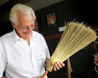 MADELYN P. HASTINGS | THE VINDICATOR
Rich Evans admires the second broom he has ever made at the Shaker Woods Festival in Columbiana on Sunday, August 18, 2013.