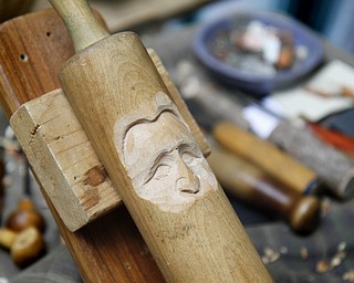 MADELYN P. HASTINGS | THE VINDICATOR
A face is carved into a rolling pin by wood carver Delaine Gerstbauer at the Shaker Woods Festival in Columbiana on Sunday, August 18, 2013.