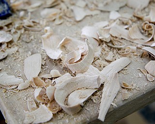 MADELYN P. HASTINGS | THE VINDICATOR
Remnants of carved wood that has fallen from a rocking horse in progress by wood carver Brett Schroyer at the Shaker Woods Festival in Columbiana on Sunday, August 18, 2013.