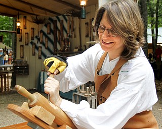 MADELYN P. HASTINGS | THE VINDICATOR
Delanie Gerstbauer carves a face into a rolling pin at the Shaker Woods Festival in Columbiana on Sunday, August 18, 2013.