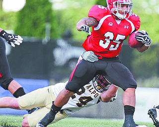 William Lewis The Vindicator YSU's Jamaine Cook(35) drags Valpo's Patrick Derbek(24) while picking up 1rst qtr yardage Saturday.