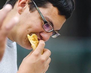 Antonio Montanez of Campbell eats a pastelillos de carne or meat pie on Sunday during the Spanish Heritage Festival.