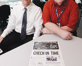 Publisher Ian Lamont, right, and editor Paul Eakins show a prototype Page One in the Long Beach Register newsroom as the staff prepares for its first day of publication at its office in Long Beach, Calif. Published by the Orange County Register, the Long Beach Register makes its five-day-a-week debut today.