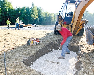 Workers with Miller-Young Paving of Bazetta, including Curtis Jones in the foreground, are shown at the new Eastlake MetroPark being created on state Route 46 just north of the Lake Vista retirement community in Cortland.