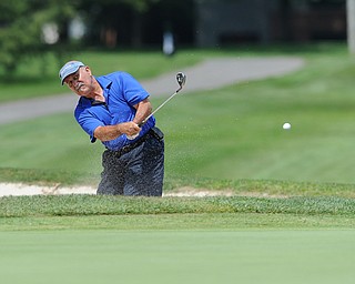 Orlando Santiago chips his ball out of the sand trap on the 12th hole Tuesday afternoon at the Trumbull Country club.