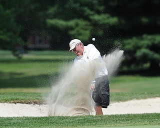 Dennis Piper of Kinsman chips his ball out of the sand trap on the 12th hole Tuesday afternoon at the Trumbull Country club.