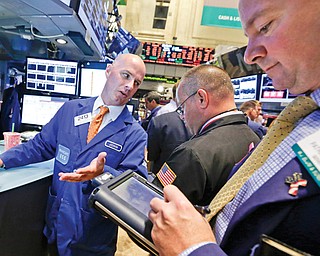 Specialist John O’Hara, left, works with traders at his post on the floor of the New York Stock Exchange. On Tuesday, the Dow Jones industrial average posted its fifth-straight day of losses, the first time that’s happened this year.