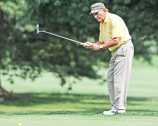 Pierre Angelilli of Youngstown encourages his ball to break toward the hole on No. 12 Tuesday afternoon at the
Trumbull Country club. Angelilli finished with an opening-round 91.