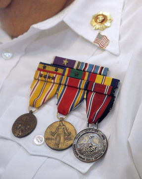  Marine Sgt. Thomas P. Smith pins Glenn Buzzard of Hubbard during a service honoring vets at Windsor House at Liberty Arms.