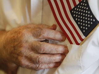 Andrew Bozin of McDonald says the pledge of Allegiance during service honoring vets at Windsor House at Liberty Arms.