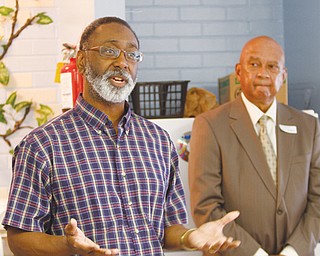 Ernie Brown, regional editor and columnist for The Vindicator, tells of his days in high school and college at the Plaza View housing complex. Thursday was career day for high school students who live there. In the background is Dr. James Hovell, a dentist and moderator for the event.