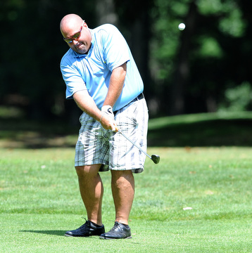 Golfer Jay Monigold of Salem chips his ball onto the green from the fairway on the 9th hole on the north course Friday afternoon at Mill Creek Golf Corse part of the Vindy Greatest Golfer on August 23, 2013.