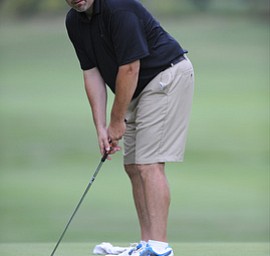 Golfer George Millich of Austintown watches his putt break toward the hole on the 18th hole on the north course Friday afternoon at Mill Creek Golf Corse part of the Vindy Greatest Golfer on August 23, 2013.