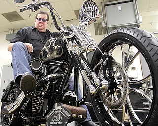 William D. Lewis\The Vindicator Dave Cook, owner of Sledgehammer Bobbers, poses with a custom motorcycle he built. His business is building an Evil Knievel tribute motorcycle.William D. Lewis\The Vindicator.