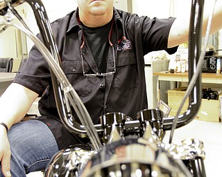 William D. Lewis\The Vindicator Dave Cook, owner of Sledgehammer Bobbers, poses with a custom motorcycle he built. His business is building an Evil Knievel tribute motorcycle.William D. Lewis\The Vindicator.