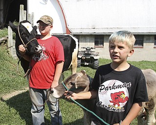 William d LEwis The Vindicator Steve Turon, 14,left, and his brother Colby, 9, on their fmily's West Farmington farm.