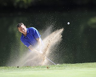 Golfer Eddie Maughan Jr. chips out of the sand trap on the 9th hole Saturday afternoon at Youngstown Country Club as part of the Vindy Greatest Golfer tournament on August 24.