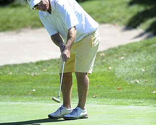 Golfer Ralph Macali of Warren follows through on his putt as it makes its way to the hole on the 9th hole Saturday afternoon at Youngstown Country Club as part of the Vindy Greatest Golfer tournament on August 24.